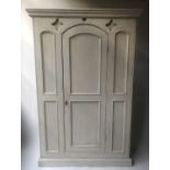 GOTHIC ARMOIRE, 19th century French traditionally grey painted with arched door enclosing hanging