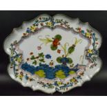 FAIENCE PLATTER, 19th century hand painted in Chinoiserie foliate decoration with scalloped edge,
