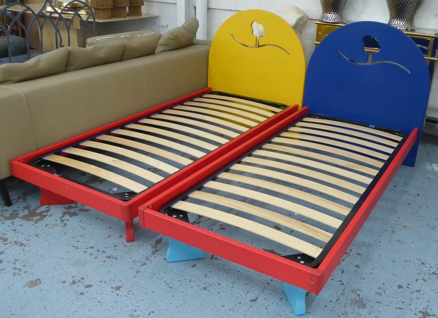 CHILDREN'S BEDS, a pair, polychrome painted finish with design cut into headboards, 195cm x 88cm x