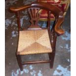 CORNER CHAIR, George III fruitwood with a curved back rail and a rush seat, 74cm W x 72cm H. (with
