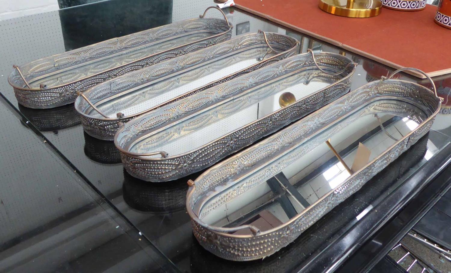 TRAYS, a set of four, mirrored bases, with handles, 61cm x 15,5cm x 5,5cm. (4)