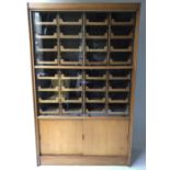 HABERDASHERY CABINET, mid 20th century English oak with two pairs of glazed doors enclosing 32