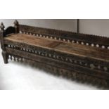 INDIAN TEMPLE BENCH, 19th century North Indian carved teak and wood with panelled seat and slatted