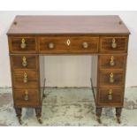 KNEEHOLE DESK, late George III, circa 1805, mahogany, with nine drawers opposed by dummy drawers and