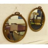 WALL MIRRORS, a pair, early 20th century French oval giltwood and gesso, each with a leaf