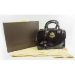 LOUIS VUITTON MELROSE BAG, monogram patent leather, goldtone hardware, buckle details at handles,