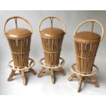 BAR STOOLS, a set of three beach house style bamboo and cane bound, tapering with foot rest, 85cm