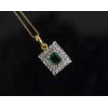 AN EMERALD AND DIAMOND PENDANT, set to the centre with a rectangular shaped emerald within two