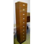 TALL NARROW FILING CABINET, oak enclosing ten compartments, each with a fall front, 40cm W 196cm H x