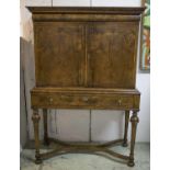 CABINET ON STAND, William and Mary walnut with a narrow drawer above two panelled doors enclosing