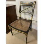 SIDE CHAIR, Regency style with a gilt and ebonised frame and cane seat, 50cm W x 85cm H.