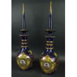 NASSER AL DINE SHAH QAGAR DECANTERS, a pair, blue ground with portrait in cartouche handpainted