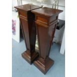 PEDESTALS, a pair, Edwardian mahogany with square tapering panelled columns, 30cm x 30cm x 115cm