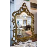 WALL MIRROR, early 20th century Italian giltwood and green painted with cartouche shaped frame, 68cm