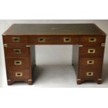 CAMPAIGN STYLE DESK, mahogany and brass bound with nine drawers, 137cm x 69cm x 77cm H.