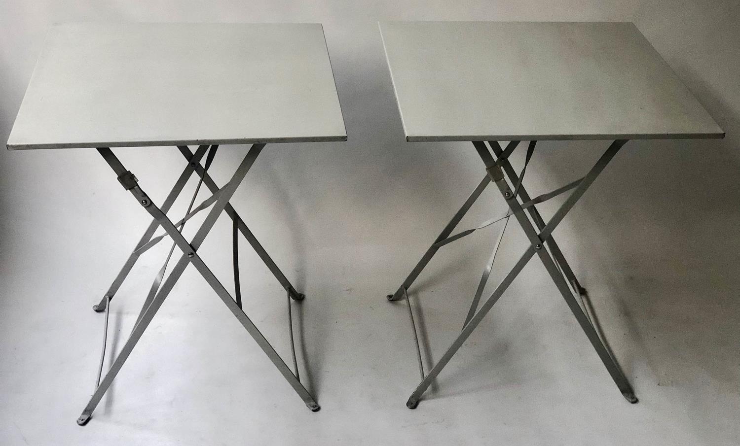 BISTRO TABLES, a pair, French grey painted, square with folding x supports, 60cm x 60cm x 72cm. (2)