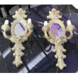 WALL SCONCES, a pair, each with two branches and an oval mirrored back plate, 75cm H x 28cm W.