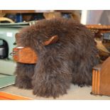 NOVELTY SHEEPSKIN FOOT STOOL MODELLED AS A HIGHLAND COW