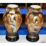 PAIR OF 9¾" JAPANESE SATSUMA VASES DECORATED WITH IMMORTALS & DRAGONS & SIGNED ON BASES, WITH WOODEN