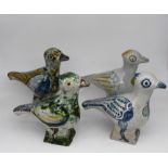 Quattro sculture in maiolica smaltata . Four enameled majolica sculptures