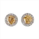 A pair of yellow and colourless diamond set cluster earrings