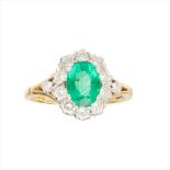 An emerald and diamond set cluster ring