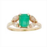 An emerald and diamond set ring