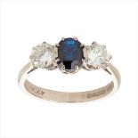 A sapphire and diamond set three stone ring