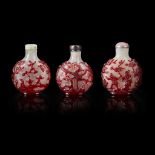 GROUP OF THREE RED OVERLAY PEKING GLASS SNUFF BOTTLES QING DYNASTY, 19TH CENTURY