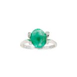 An emerald and diamond set ring