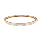 A 9ct gold diamond set bangle