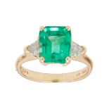 An emerald and diamond set ring