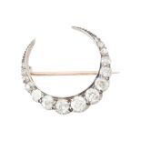 A Victorian diamond set crescent brooch