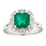 An 18ct gold emerald and diamond set cluster ring