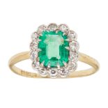 An emerald and diamond set cluster ring