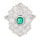 An emerald and diamond cluster ring