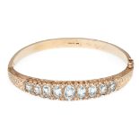 A 9ct gold aquamarine and diamond set bangle