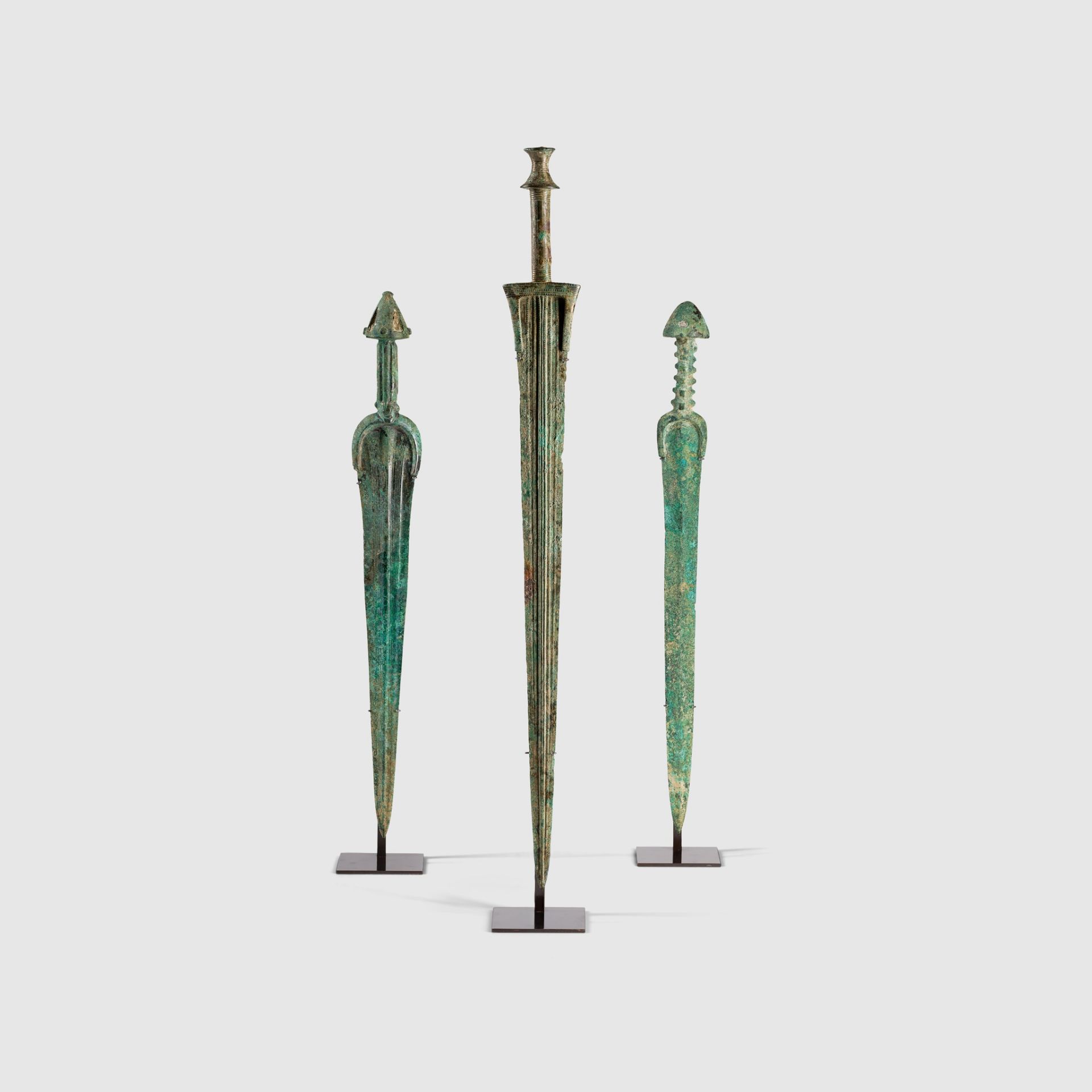 TRIO OF NEAR EASTERN SWORDS NEAR EAST, EARLY FIRST MILLENIUM B.C.