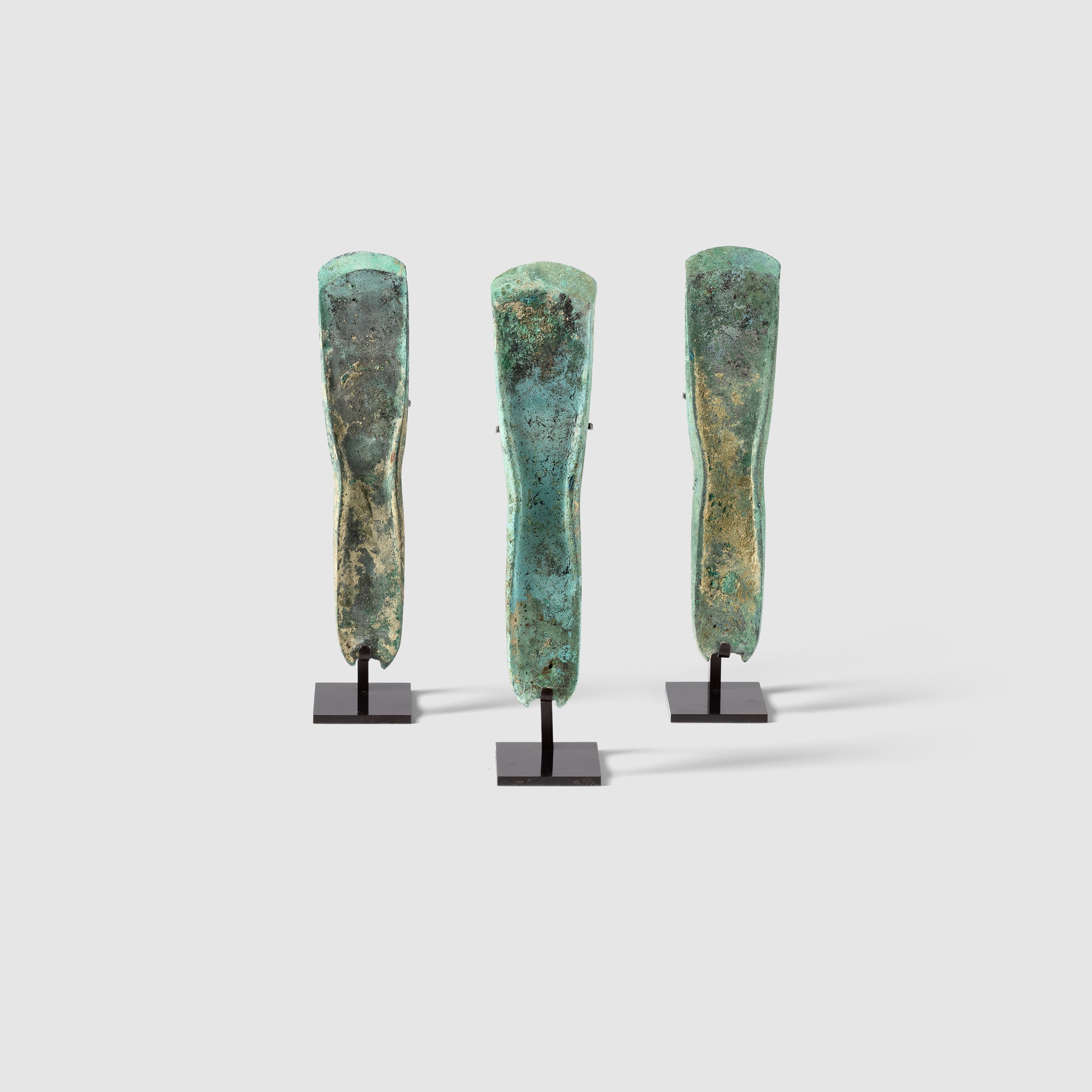 THREE BRONZE AGE AXES EUROPE, MIDDLE BRONZE AGE, C. 1400 B.C.