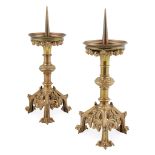 ENGLISH SCHOOL PAIR OF GOTHIC REVIVAL BRASS PRICKET CANDLESTICKS, CIRCA 1870