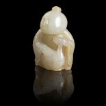 PALE CELADON WITH YELLOW SKIN JADE CARVING OF A BOY AND GOOSE QING DYNASTY, 18TH CENTURY