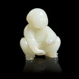PALE CELADON JADE CARVING OF A SQUATTED BOY QING DYNASTY, 18TH CENTURY