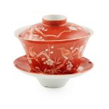 RED-GROUND RESERVE-DECORATED 'PRUNUS' LIDDED CUP AND SAUCER DAOGUANG MARK
