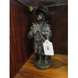 A bronze finish figure of a young boy dressed in military clothing with binoculars around his