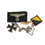 A German Iron Cross, dated 1914, on a neck chain, two cloth badges and a brass RAF eagle badge