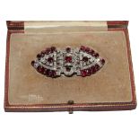 A diamond and ruby double clip circa 1940, breaking down to two clips and a brooch