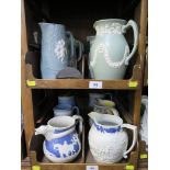 Twelve relief moulded jasperware jugs by Wedgwood, Dudson and others, many with hunting scenes,