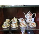 A Japanese coffee service, with five cups and saucers, depicting pagodas in an autumnal mountain