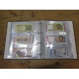 An album of international banknotes including Nigeria, Zambia, Romania, Vietnam etc