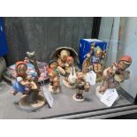 Six Hummel figures, including 'Umbrella Boy', 'Merry Wanderer (Oberammergau 2000), a Hummel